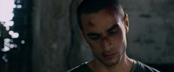 Movie still from “Omar” (2013), directed by Hany Abu-Assad – A person with blood on his face; Close Up shot, Over the shoulder angle