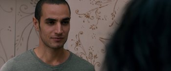Movie still from “Omar” (2013), directed by Hany Abu-Assad – A person wearing a green shirt; Close Up shot, Over the shoulder angle