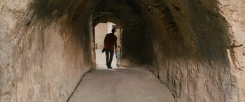 Movie still from “Omar” (2013), directed by Hany Abu-Assad – A man and a child walking down a tunnel; Extreme Wide shot, Over the shoulder angle