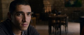 Movie still from “Omar” (2013), directed by Hany Abu-Assad – A man's face in front of a table; Close Up shot, Over the shoulder angle