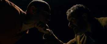 Movie still from “Omar” (2013), directed by Hany Abu-Assad – A man and a man touching each other's neck; Close Up shot, Over the shoulder angle