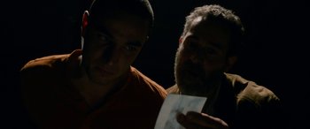 Movie still from “Omar” (2013), directed by Hany Abu-Assad – Two men are looking at a piece of paper; Close Up shot, Over the shoulder angle