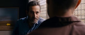 Movie still from “Omar” (2013), directed by Hany Abu-Assad – A man with a goatee is looking at another man with a goatee; Close Up shot, Over the shoulder angle