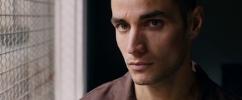 Movie still from “Omar” (2013), directed by Hany Abu-Assad – A man's face in front of a window; Close Up shot, Low angle