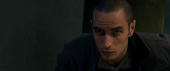 Movie still from “Omar” (2013), directed by Hany Abu-Assad – A person looking at the camera; Close Up shot, High angle