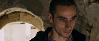 Movie still from “Omar” (2013), directed by Hany Abu-Assad – A person wearing a black jacket; Close Up shot, Over the shoulder angle
