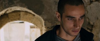 Movie still from “Omar” (2013), directed by Hany Abu-Assad – A person wearing a black jacket; Close Up shot, Over the shoulder angle