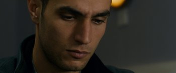 Movie still from “Omar” (2013), directed by Hany Abu-Assad – A man's face with his eyes wide open; Close Up shot, Low angle