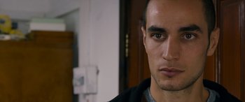 Movie still from “Omar” (2013), directed by Hany Abu-Assad – A man's face in front of a door; Close Up shot, Over the shoulder angle