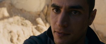 Movie still from “Omar” (2013), directed by Hany Abu-Assad – A person's face with a mountain in the background; Close Up shot, Over the shoulder angle