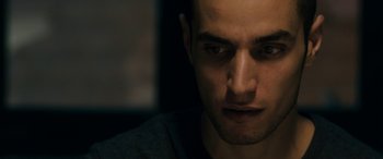 Movie still from “Omar” (2013), directed by Hany Abu-Assad – A man's face in the dark; Close Up shot, Low angle