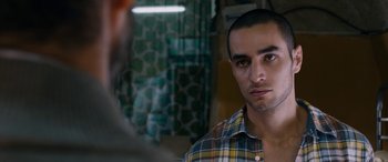 Movie still from “Omar” (2013), directed by Hany Abu-Assad – A man in a plaid shirt looking at a man in a plaid shirt; Close Up shot, Over the shoulder angle