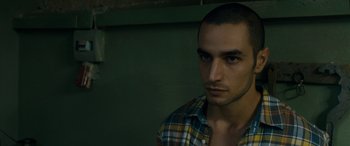 Movie still from “Omar” (2013), directed by Hany Abu-Assad – A person wearing a plaid shirt; Close Up shot, High angle