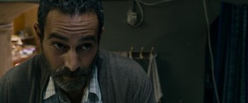 Movie still from “Omar” (2013), directed by Hany Abu-Assad – A person with a beard; Close Up shot, High angle