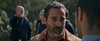 Movie still from “Omar” (2013), directed by Hany Abu-Assad – A person with a beard; Close Up shot, Over the shoulder angle