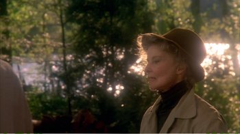 Movie still from “On Golden Pond” (1981), directed by Mark Rydell – An older woman wearing a brown hat and a trench coat; Close Up shot, Low angle
