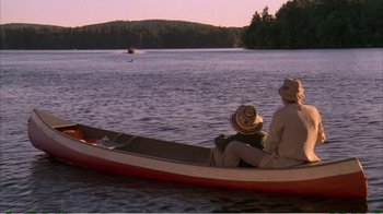 Movie still from “On Golden Pond” (1981), directed by Mark Rydell – Two people are in a canoe on a lake; Wide shot, High angle