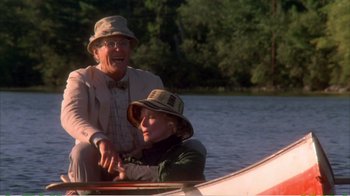 Movie still from “On Golden Pond” (1981), directed by Mark Rydell – A man and a woman sitting in a boat on a lake; Medium shot, Low angle