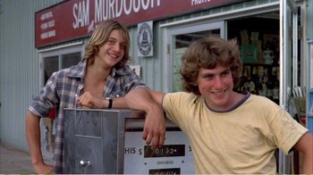 Movie still from “On Golden Pond” (1981), directed by Mark Rydell – Two young men leaning against a metal box; Medium shot, Low angle