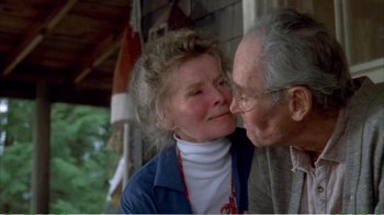 Movie still from “On Golden Pond” (1981), directed by Mark Rydell – An older man kissing a woman's cheek outside; Close Up shot, High angle