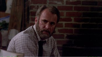 Movie still from “On Golden Pond” (1981), directed by Mark Rydell – A man in a plaid shirt and a black tie; Close Up shot, Low angle