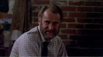 Movie still from “On Golden Pond” (1981), directed by Mark Rydell – A man with a gray beard wearing a tie; Close Up shot, Low angle