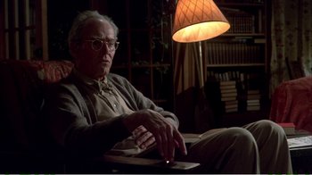 Movie still from “On Golden Pond” (1981), directed by Mark Rydell – An older man sitting in a chair in front of a lamp; Medium shot, Low angle