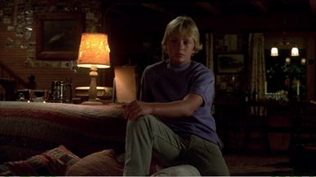 Movie still from “On Golden Pond” (1981), directed by Mark Rydell – A boy sitting on a couch in a living room; Medium shot, Low angle
