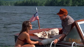 Movie still from “On Golden Pond” (1981), directed by Mark Rydell – A man and a woman sitting on a wooden boat; Medium shot, High angle