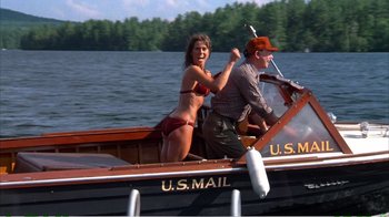 Movie still from “On Golden Pond” (1981), directed by Mark Rydell – A man and a woman riding a boat on a lake; Wide shot, Low angle