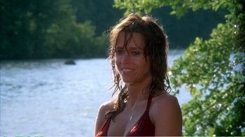 Movie still from “On Golden Pond” (1981), directed by Mark Rydell – A woman in a red bathing suit standing next to a body of water; Close Up shot, Over the shoulder angle