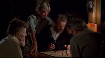 Movie still from “On Golden Pond” (1981), directed by Mark Rydell – A group of people sitting at a table playing a board game; Medium shot, High angle