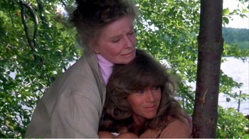 Movie still from “On Golden Pond” (1981), directed by Mark Rydell – Two women embracing each other in front of a tree; Medium shot, Over the shoulder angle