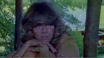 Movie still from “On Golden Pond” (1981), directed by Mark Rydell – A young woman with long brown curly hair posing for the camera; Close Up shot, Overhead angle