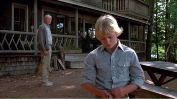 Movie still from “On Golden Pond” (1981), directed by Mark Rydell – A man and a boy standing in front of a house; Medium shot, Low angle
