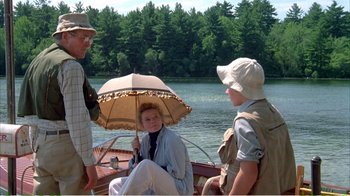 Movie still from “On Golden Pond” (1981), directed by Mark Rydell – A group of people sitting on a boat in the water; Wide shot, High angle