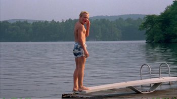 Movie still from “On Golden Pond” (1981), directed by Mark Rydell – A man standing on a dock in the middle of a lake; Wide shot, Low angle