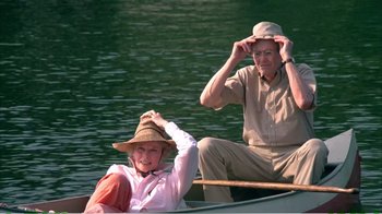 Movie still from “On Golden Pond” (1981), directed by Mark Rydell – An older man and a younger woman in a row boat; Medium shot, High angle