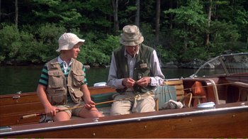 Movie still from “On Golden Pond” (1981), directed by Mark Rydell – A man and a woman sitting in a boat on the water; Medium shot, High angle