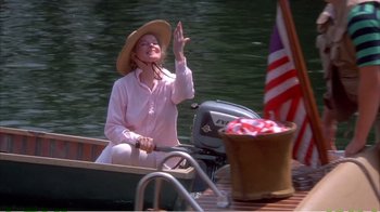 Movie still from “On Golden Pond” (1981), directed by Mark Rydell – A woman in a boat waving at the camera; Medium shot, High angle