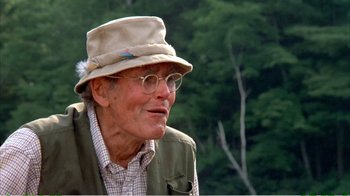 Movie still from “On Golden Pond” (1981), directed by Mark Rydell – An older man wearing a hat and glasses; Close Up shot, Low angle