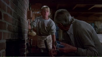 Movie still from “On Golden Pond” (1981), directed by Mark Rydell – An older man and a young boy in front of a fireplace; Medium shot, Low angle