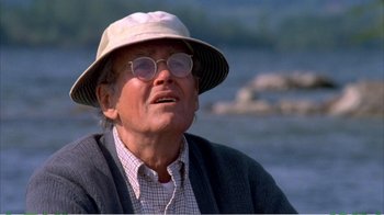 Movie still from “On Golden Pond” (1981), directed by Mark Rydell – An older man wearing glasses and a hat; Close Up shot, Low angle