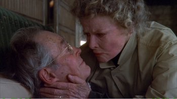 Movie still from “On Golden Pond” (1981), directed by Mark Rydell – An older man and a younger woman touching each other; Close Up shot, Low angle