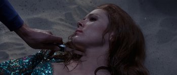 Movie still from “On Her Majesty's Secret Service” (1969), directed by Peter R. Hunt – A person cutting a woman's hair; Close Up shot, Overhead angle