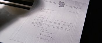 Movie still from “On Her Majesty's Secret Service” (1969), directed by Peter R. Hunt – An old letter is shown on top of a table; Extreme Close Up shot, Overhead angle