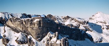 Movie still from “On Her Majesty's Secret Service” (1969), directed by Peter R. Hunt – A view of a mountain range with snow on it's slopes; Extreme Wide shot, Low angle