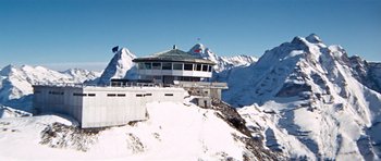 Movie still from “On Her Majesty's Secret Service” (1969), directed by Peter R. Hunt – A building on top of a snowy mountain; Extreme Wide shot, High angle