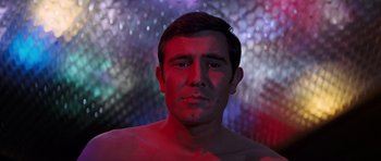Movie still from “On Her Majesty's Secret Service” (1969), directed by Peter R. Hunt – A person wearing a shirt; Close Up shot, Low angle