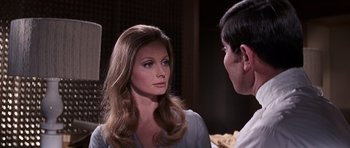 Movie still from “On Her Majesty's Secret Service” (1969), directed by Peter R. Hunt – A man and a woman talking to each other; Close Up shot, Over the shoulder angle